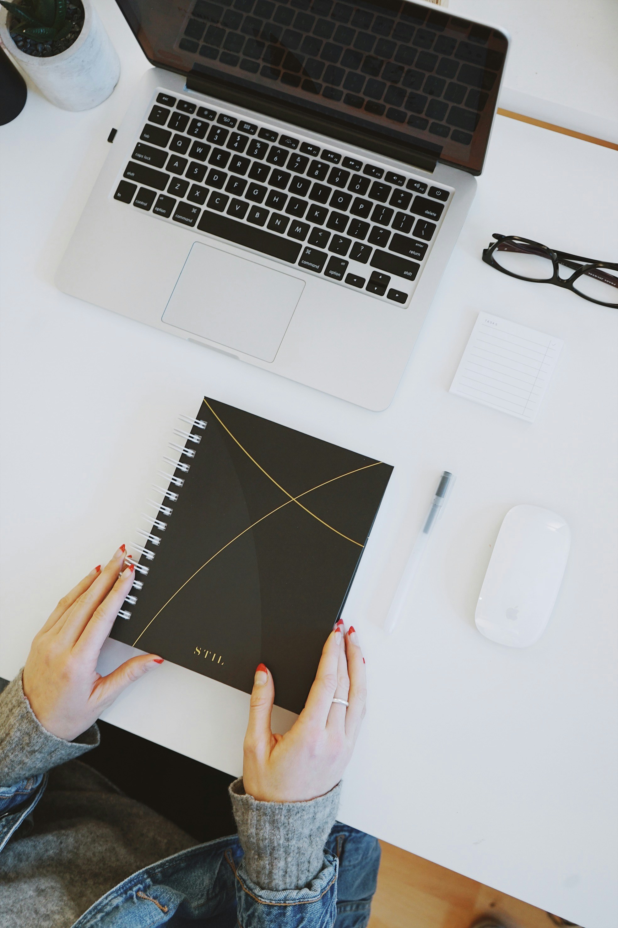 Woman holding notebook on desk